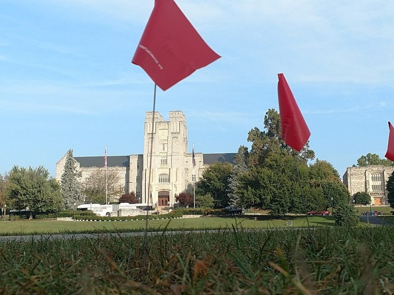 Red Flag Campaign Burruss Photo of red flags in the foreground and Burruss Hall in the background